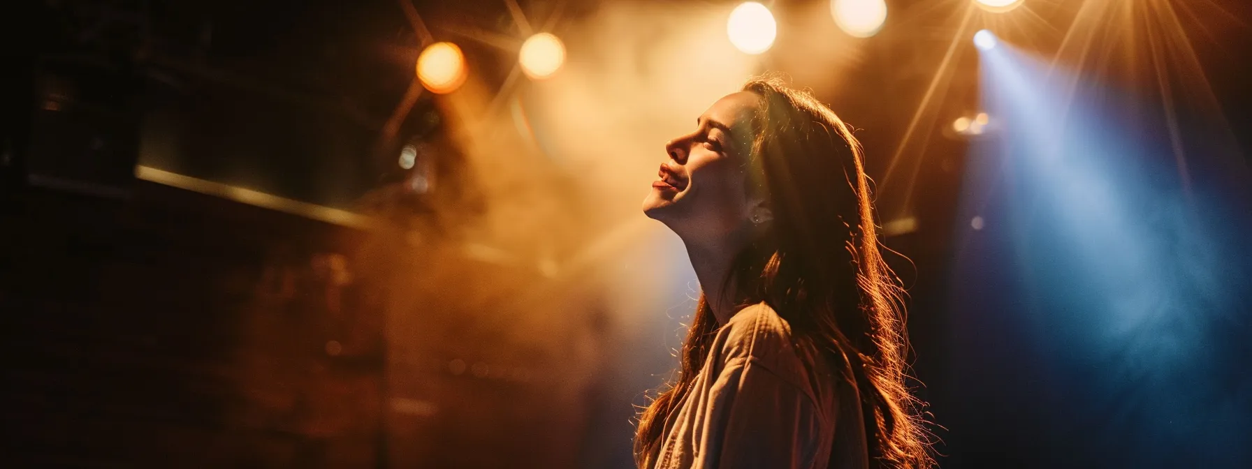 a spotlight shining on taylor tomlinson on a dimly lit stage, capturing her confidence and charisma as a successful comedian.